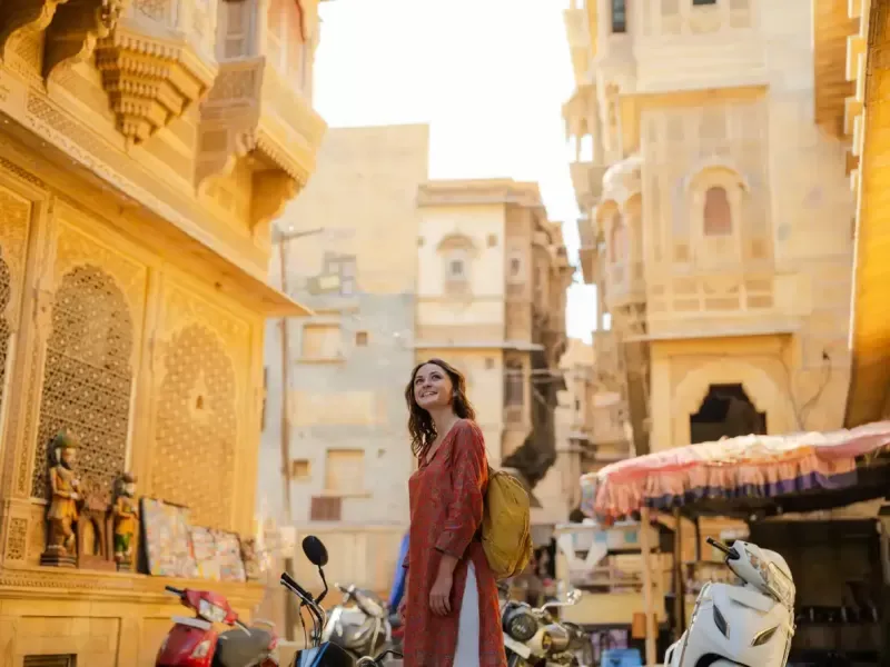  Woman walking on crowded street in old town of Jaisalmer,